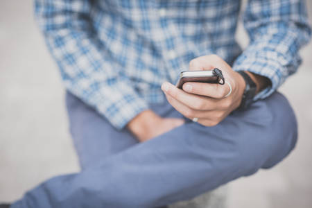 close up hand man using smartphone in the cityの写真素材