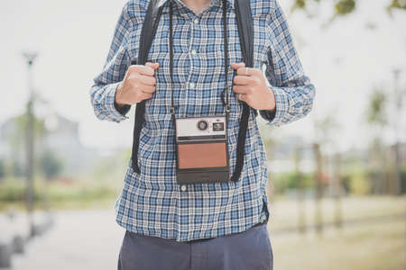 handsome hipster casual multitasking modern man with vintage camera in the cityの写真素材