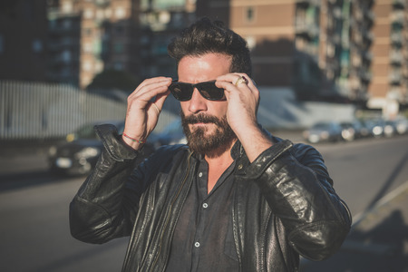 young handsome attractive bearded model man in urban contextの写真素材