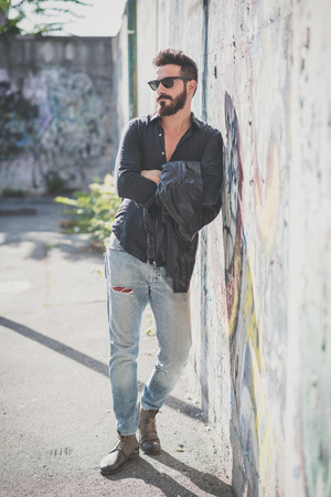 young handsome attractive bearded model man in urban contextの写真素材