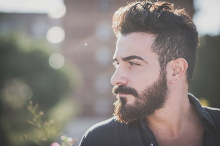 young handsome attractive bearded model man in urban contextの写真素材