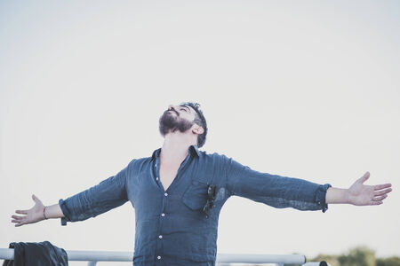 young handsome attractive bearded model man in urban contextの写真素材