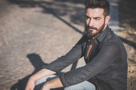 young handsome attractive bearded model man in urban contextの写真素材