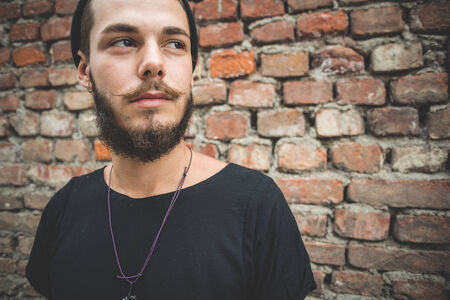 young handsome bearded hipster man in the cityの写真素材