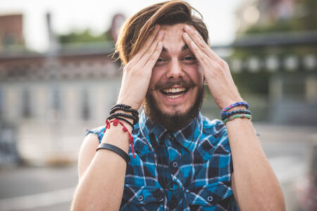 young handsome bearded hipster man in the cityの写真素材