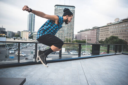 young handsome bearded hipster man in the cityの写真素材