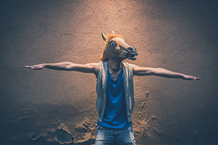 horse mask young hipster man in the cityの写真素材