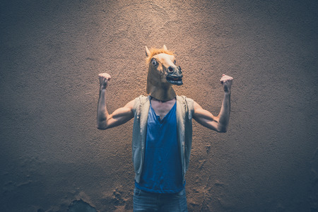 horse mask young hipster man in the cityの写真素材