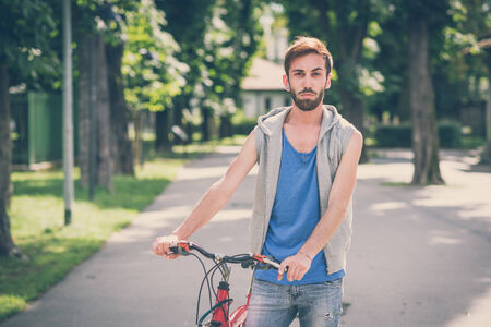 young hipster man with bikeの写真素材
