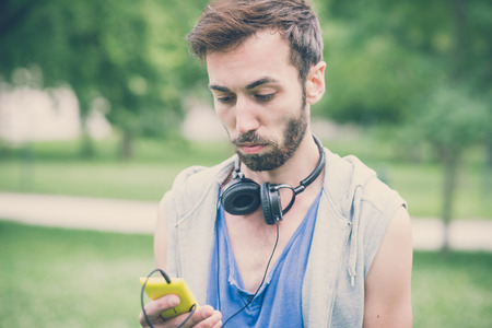 young hipster man listening music with headphonesの写真素材