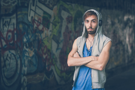 young hipster man listening music with headphonesの写真素材
