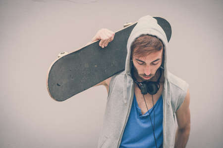 young hipster man with skate boardの写真素材