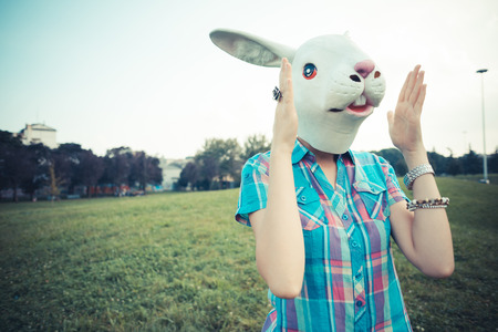 rabbit mask absurd beautiful young hipster woman in the cityの写真素材