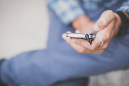 close up hand man using smartphone in the city
