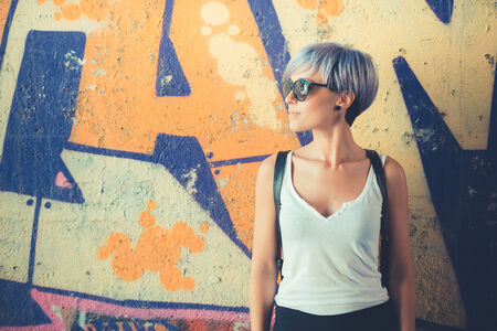 young beautiful short blue hair hipster woman in the cityの写真素材