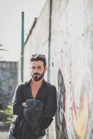 young handsome attractive bearded model man in urban contextの写真素材