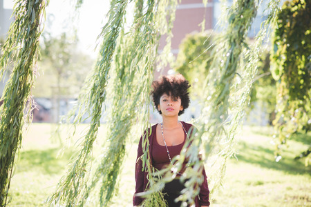 beautiful black curly hair african woman in townの写真素材