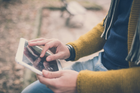 close up of hands man using tablet outdoor - technological device connected wireless