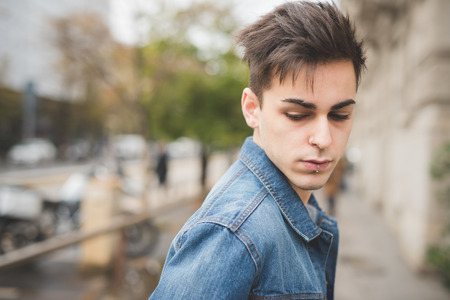 young handsome alternative dark model man in townの写真素材