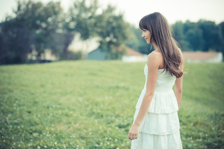 beautiful young woman with white dress in the cityの写真素材