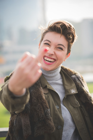 young beautiful short hair hipster woman in townの写真素材