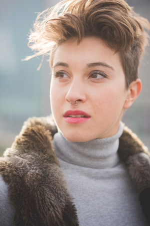 young beautiful short hair hipster woman in townの写真素材