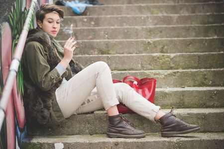 young beautiful short hair hipster woman in townの写真素材