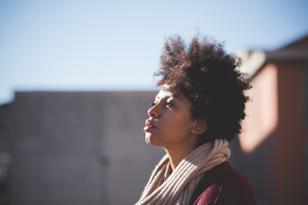 beautiful black curly hair african woman in townの写真素材