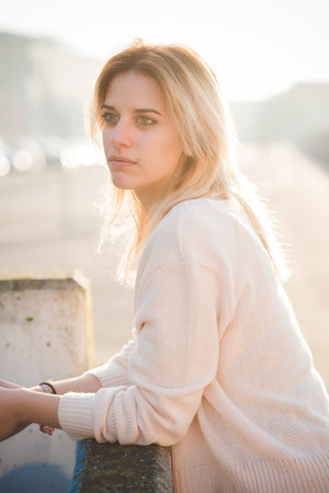 young beautiful blonde woman outdoor in the street of the cityの写真素材