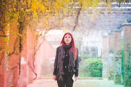 young beautiful red hair venezuelan woman lifestyle in the city of milan outdoor street