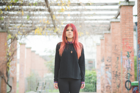 young beautiful red hair venezuelan woman lifestyle in the city of milan outdoor street