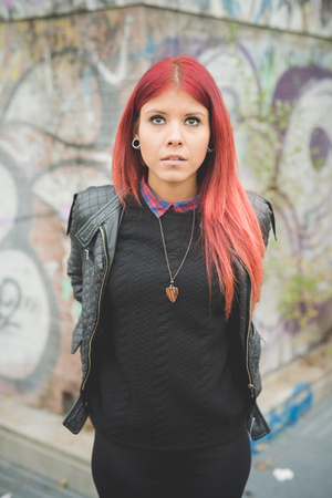 young beautiful red hair venezuelan woman lifestyle in the city of milan outdoor streetの写真素材