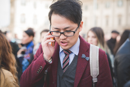 MILAN, ITALY - FEBRUARY 25: People during Milan Fashion week, Italy on February, 25 2015. Eccentric and fashionable people outside city during Milan fashion week wait for models and famous peopleのeditorial素材