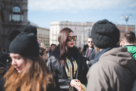 MILAN, ITALY - FEBRUARY 25: People during Milan Fashion week, Italy on February, 25 2015. Eccentric and fashionable people outside city during Milan fashion week wait for models and famous peopleのeditorial素材