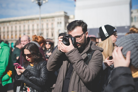 MILAN, ITALY - FEBRUARY 25: People during Milan Fashion week, Italy on February, 25 2015. Eccentric and fashionable people outside city during Milan fashion week wait for models and famous peopleのeditorial素材