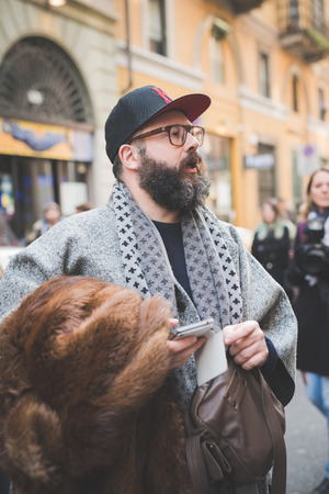MILAN, ITALY - FEBRUARY 27: People during Milan Fashion week, Italy on February, 27 2015. Eccentric and fashionable people outside city during Milan fashion week wait for models and famous peopleのeditorial素材