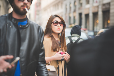 MILAN, ITALY - FEBRUARY 27: People during Milan Fashion week, Italy on February, 27 2015. Eccentric and fashionable people outside city during Milan fashion week wait for models and famous peopleのeditorial素材