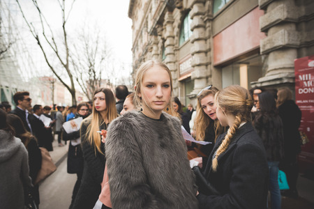 MILAN, ITALY - FEBRUARY 28: People during Milan Fashion week, Italy on February, 28 2015. Eccentric and fashionable people outside city during Milan fashion week wait for models and famous peopleのeditorial素材
