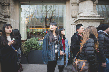 MILAN, ITALY - FEBRUARY 28: People during Milan Fashion week, Italy on February, 28 2015. Eccentric and fashionable people outside city during Milan fashion week wait for models and famous peopleのeditorial素材