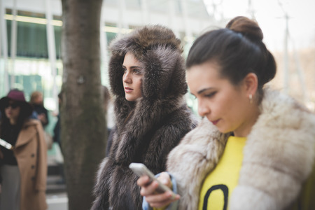 MILAN, ITALY - FEBRUARY 28: People during Milan Fashion week, Italy on February, 28 2015. Eccentric and fashionable people outside city during Milan fashion week wait for models and famous peopleのeditorial素材