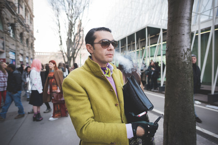 MILAN, ITALY - FEBRUARY 28: People during Milan Fashion week, Italy on February, 28 2015. Eccentric and fashionable people outside city during Milan fashion week wait for models and famous peopleのeditorial素材
