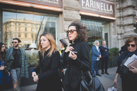 MILAN, ITALY - FEBRUARY 28: People during Milan Fashion week, Italy on February, 28 2015. Eccentric and fashionable people outside city during Milan fashion week wait for models and famous peopleのeditorial素材