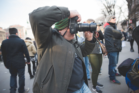 MILAN, ITALY - FEBRUARY 28: People during Milan Fashion week, Italy on February, 28 2015. Eccentric and fashionable people outside city during Milan fashion week wait for models and famous peopleのeditorial素材
