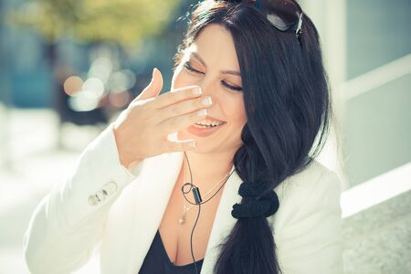 beautiful long black hair elegant business woman using smartphone  in the cityの写真素材