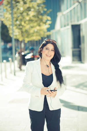 beautiful long black hair elegant business woman using smartphone  in the cityの写真素材