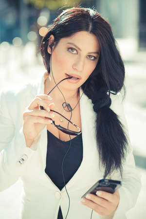 beautiful long black hair elegant business woman using smartphone  in the cityの写真素材