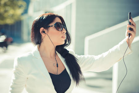 beautiful long black hair elegant business woman using smartphone  in the cityの写真素材