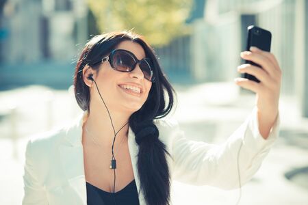 beautiful long black hair elegant business woman using smartphone  in the cityの写真素材