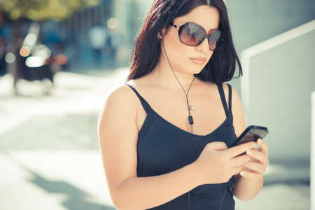 beautiful long black hair elegant business woman using smartphone  in the cityの写真素材