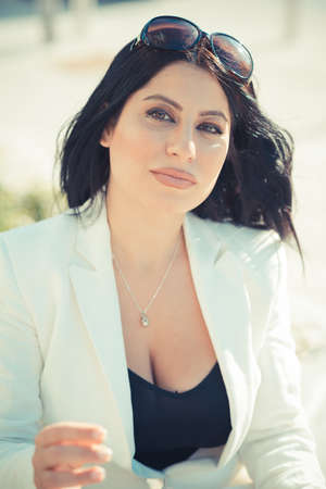 beautiful long black hair elegant business woman using tablet in the cityの写真素材